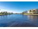 Wide canal and waterfront view with lush green lawns and other upscale homes at 4431 Gardner Dr, Port Charlotte, FL 33952