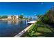 Beautiful waterfront featuring a private dock and boat lift system, set against a backdrop of a well-manicured lawn at 4431 Gardner Dr, Port Charlotte, FL 33952