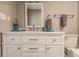 Bathroom with white vanity, large mirror, and walk-in shower at 69 Sabal Dr, Punta Gorda, FL 33950