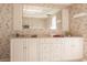 Double vanity bathroom with floral wallpaper and mirror at 69 Sabal Dr, Punta Gorda, FL 33950