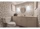 Clean bathroom with floral wallpaper, a vanity, and toilet at 69 Sabal Dr, Punta Gorda, FL 33950