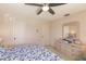 Bright bedroom with a floral bedspread, dresser, and mirror at 69 Sabal Dr, Punta Gorda, FL 33950