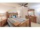 King-size bedroom with wood furniture and ceiling fan at 69 Sabal Dr, Punta Gorda, FL 33950