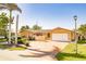 Single-story home with a large driveway and palm trees at 69 Sabal Dr, Punta Gorda, FL 33950