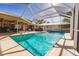 Inviting pool area with screened enclosure, ample seating, and a spacious deck at 69 Sabal Dr, Punta Gorda, FL 33950