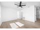 Bright living room with wood-look tile floors and a ceiling fan at 9466 Tacoma Ave, Englewood, FL 34224