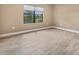 Empty bedroom with large window and tile floors at 11137 Mcdermott Ct, Englewood, FL 34223