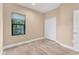 Well-lit bedroom, featuring tile floors and a closet at 11137 Mcdermott Ct, Englewood, FL 34223