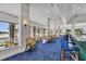Modern community bar with blue barstools and large windows at 11137 Mcdermott Ct, Englewood, FL 34223