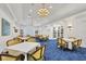 Elegant community room with tables, chairs, and built-in bookshelves at 11137 Mcdermott Ct, Englewood, FL 34223