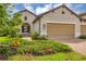 Beige two-story house with a two-car garage and landscaped front yard at 11137 Mcdermott Ct, Englewood, FL 34223