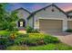 Two-story home with a two-car garage and landscaping at 11137 Mcdermott Ct, Englewood, FL 34223