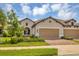 Two-story home with a two-car garage and landscaping at 11137 Mcdermott Ct, Englewood, FL 34223