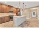 Modern kitchen with stainless steel appliances and an island at 11137 Mcdermott Ct, Englewood, FL 34223