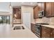 Modern kitchen with stainless steel appliances and a large island at 11137 Mcdermott Ct, Englewood, FL 34223