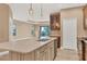 Modern kitchen with stainless steel appliances and a large island at 11137 Mcdermott Ct, Englewood, FL 34223