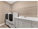 Laundry room with washer, dryer, and shelving at 11137 Mcdermott Ct, Englewood, FL 34223