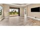 Spacious living room with tile floors, recessed lighting, and access to a patio at 11137 Mcdermott Ct, Englewood, FL 34223