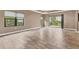 Spacious living area with large windows, tile floors, and access to a patio at 11137 Mcdermott Ct, Englewood, FL 34223
