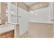 Large walk-in shower with white tile surround at 11137 Mcdermott Ct, Englewood, FL 34223