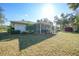 Landscaped backyard with screened patio at 157 Troutdale St, Port Charlotte, FL 33954