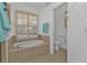 Bathroom with a large garden tub, a separate toilet area, and a shower at 1766 Dunvegan Dr, Punta Gorda, FL 33980
