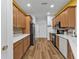 Modern kitchen with light wood cabinets, stainless steel appliances, and white countertops at 1766 Dunvegan Dr, Punta Gorda, FL 33980