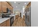 Well-equipped kitchen featuring light wood cabinets, stainless steel appliances, and ample counter space at 1766 Dunvegan Dr, Punta Gorda, FL 33980
