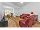 Spacious living room featuring hardwood floors and comfortable red leather seating at 1766 Dunvegan Dr, Punta Gorda, FL 33980