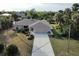 Aerial view of a single story home with driveway and landscaping at 18345 Ohara Dr, Port Charlotte, FL 33948