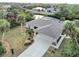 Aerial view of canal-front home with lush landscaping and pool at 18345 Ohara Dr, Port Charlotte, FL 33948