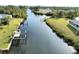 Aerial view of a canal with multiple properties and boat lifts at 18345 Ohara Dr, Port Charlotte, FL 33948