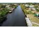 Aerial view of canal-front property with private dock and lush landscaping at 18345 Ohara Dr, Port Charlotte, FL 33948