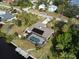 Aerial view of canal-front home with pool and dock at 18345 Ohara Dr, Port Charlotte, FL 33948