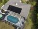 Aerial view showcasing a home with a pool and solar panels at 18345 Ohara Dr, Port Charlotte, FL 33948