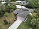 Aerial view of canal-front home with lush landscaping and pool at 18345 Ohara Dr, Port Charlotte, FL 33948