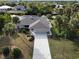 Aerial view of canal front home with a large driveway at 18345 Ohara Dr, Port Charlotte, FL 33948