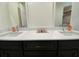 Double vanity bathroom with white quartz countertop and dark cabinets at 18345 Ohara Dr, Port Charlotte, FL 33948