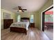 Main bedroom with wood flooring, ceiling fan, and access to private balcony at 18345 Ohara Dr, Port Charlotte, FL 33948