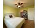 Bedroom with ceiling fan, built-in shelving, and hardwood floors at 18345 Ohara Dr, Port Charlotte, FL 33948