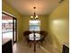 Charming breakfast nook with glass-top table and wicker chairs, overlooking the pool at 18345 Ohara Dr, Port Charlotte, FL 33948