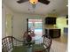 Bright dining area with seamless access to the pool through sliding doors, with view of the modern kitchen at 18345 Ohara Dr, Port Charlotte, FL 33948