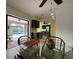 Dining area with glass table and view of kitchen and pool at 18345 Ohara Dr, Port Charlotte, FL 33948