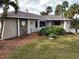 Home exterior showcasing stone accents and landscaping at 18345 Ohara Dr, Port Charlotte, FL 33948