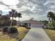 Single-story home with attached garage and landscaped yard at 18345 Ohara Dr, Port Charlotte, FL 33948