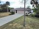 Property's front yard showcasing home's exterior and driveway at 18345 Ohara Dr, Port Charlotte, FL 33948