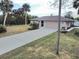 Property's front yard showcasing home's exterior and driveway at 18345 Ohara Dr, Port Charlotte, FL 33948