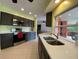 Modern kitchen with stainless steel appliances, quartz countertops, and dark cabinets. Stainless dual sink by window at 18345 Ohara Dr, Port Charlotte, FL 33948