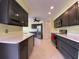 Modern kitchen with dark cabinetry and stainless steel appliances at 18345 Ohara Dr, Port Charlotte, FL 33948