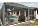 This screened-in pool area includes ample seating and a grill at 18345 Ohara Dr, Port Charlotte, FL 33948